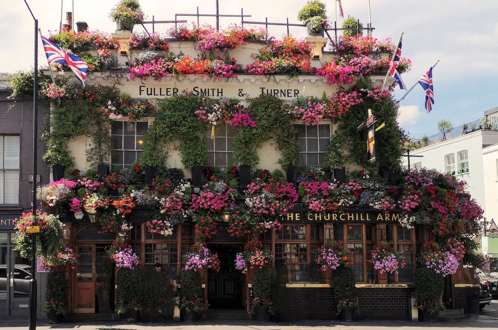 The Churchill Arms in Kensington, its whole front covered in flowers and hanging baskets